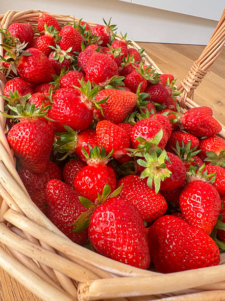 istock Fresh Strawberries in a Wicker Basket Display 2218394748