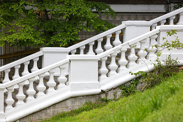 istock A white staircase with white balusters and a green tree in the background 2218396121