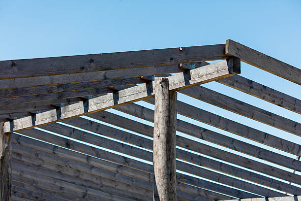 New attic is under construction, unfinished with roofing wooden truss, beams.
