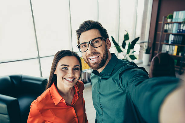 istock Young professionals taking a workplace selfie symbolizing team success and collaboration in a modern office setting 2218397033