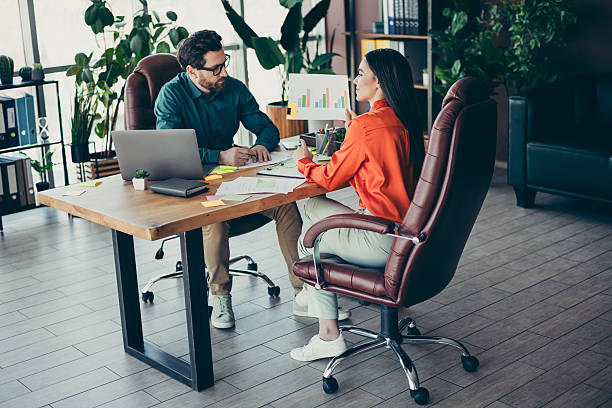 istock Young professionals work together on a project in a modern office, fostering teamwork and collaboration among coworkers 2218397094