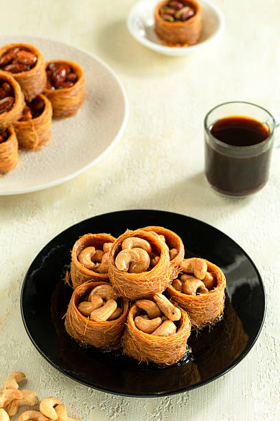 istock Cashew rolls (Asawer), Arabic pastries sweetened with syrup, filled with roasted nuts 2218399617