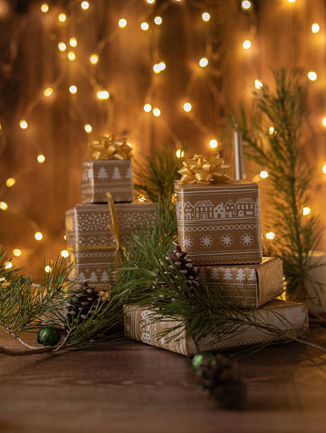 istock Festive Holiday Decor with Wrapped Presents and Pine Branches Showcasing Elegant Gift Ideas for Seasonal Celebrations Under Warm String Lights 2218401252