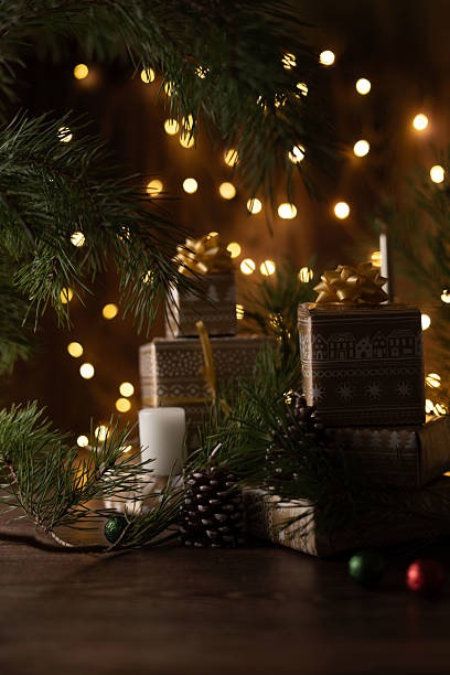 istock Cozy Holiday Setting with Pine Branches, Wrapped Gift Boxes, and Glowing Festive Lights Evoking a Warm Christmas Atmosphere in a Rustic and Natural Decor 2218401261