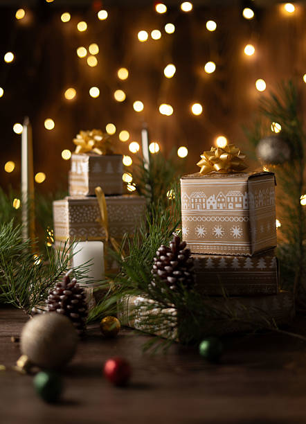 istock Captivating Holiday Gift Arrangement with Elegant Wrapping Ideas, Illuminating Christmas Decor, Pine Cones, and Festive Lights Creating a Warm Seasonal Ambiance 2218401263