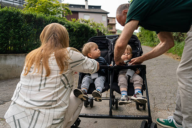 istock Grandparents getting ready for a walk with toddler twin boys in stroller 2218401628