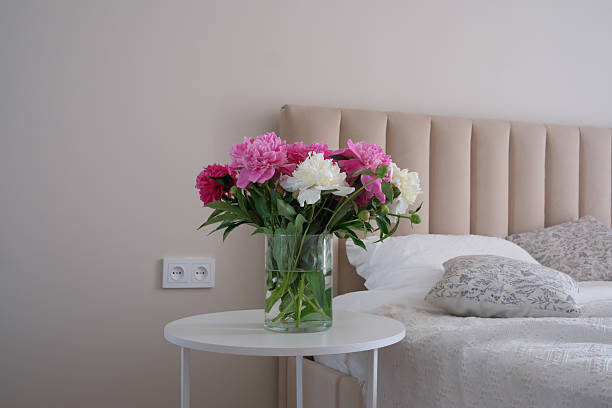 istock A Beautiful Peony Bouquet Arranged in an Elegant Glass Vase Sitting on a Side Table 2218401924