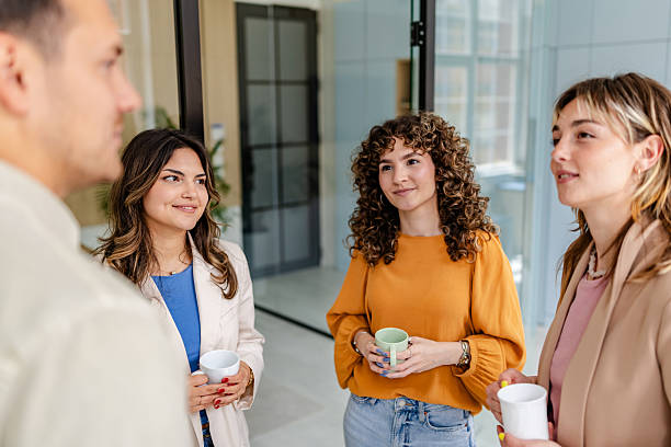 istock Colleagues engage in a lively conversation during a break in a modern office setting 2218403130