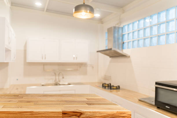 istock Empty wooden tabletop with blurred modern kitchen background for product display, cooking or food presentation 2218403491