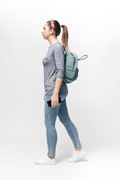 istock Young woman with a backpack on her shoulders walking. 2218403993
