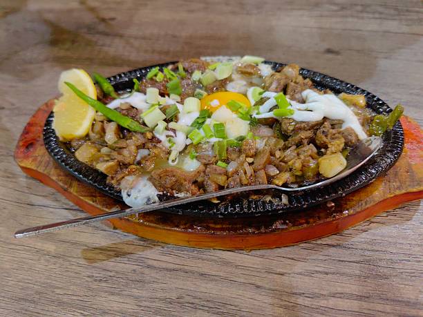 istock Delicious Sauted beef with sunny set up egg and vegetable on top served on a plate. 2218404075