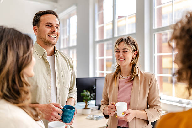 istock Colleagues enjoying a casual conversation in a modern office environment during a work break 2218404258