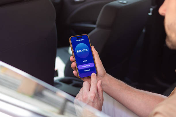 istock Young man relaxing in car using a breathing app on smartphone 2218405549