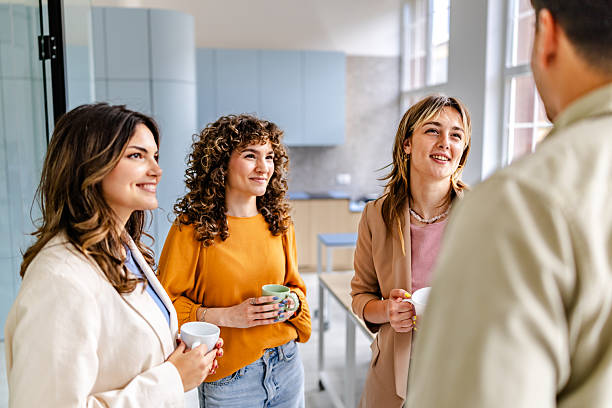 istock Engaged colleagues share ideas and laughter during a break in a modern office environment 2218405552