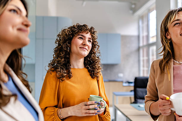 istock Engaging conversation among colleagues in a modern office setting while enjoying coffee together 2218405938