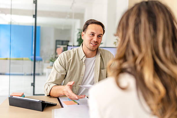 istock Engaging conversation between colleagues in a modern office setting fostering teamwork and collaboration 2218406103
