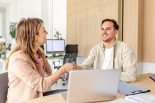 istock Engaging discussion between colleagues in a modern office environment during a productive workday 2218406594