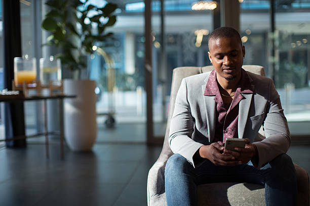 istock Young man relaxing in a Hotel lobby sofa 2218406947