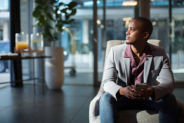 istock Young man relaxing in a Hotel lobby sofa 2218406974