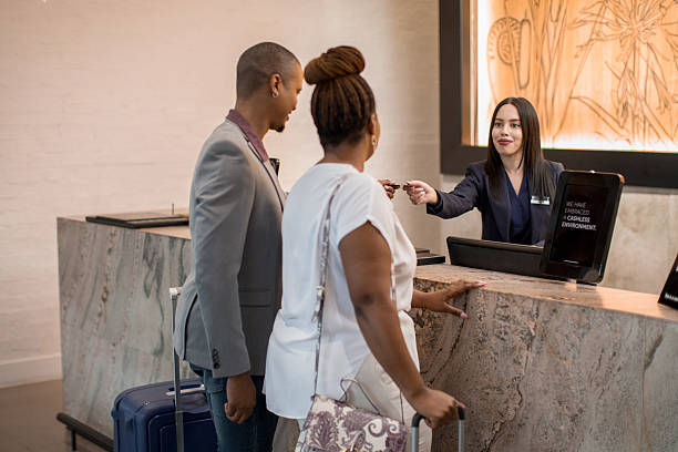 istock Happy couple checking-in at the Hotel reception desk 2218407099