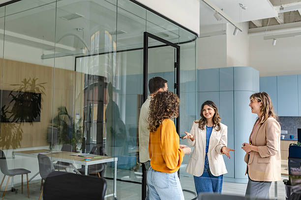 istock Group of colleagues engaging in discussion in a modern office setting during a busy workday 2218407122