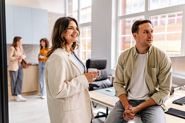 istock Modern office atmosphere with engaged colleagues enjoying conversation during work hours 2218407326
