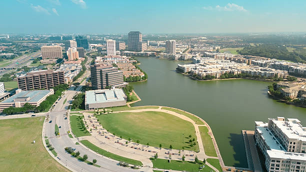 istock Lake Carolyn mixed-use development community in downtown Las Colinas, Irving, high-rise office buildings, lakeside residential complexes, entertainment venues, shops, multi-level parking garage 2218408334