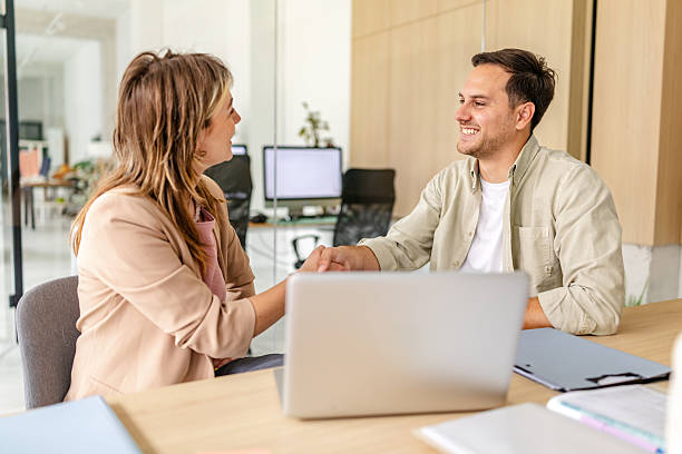 istock Professional colleagues engaging in a friendly handshake in a modern office environment 2218409114