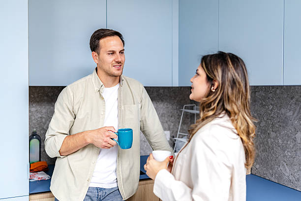 istock Professional conversation in a modern office kitchen with colleagues enjoying their coffee break 2218409160