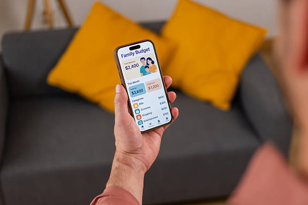 istock Man managing family budget using mobile app at home 2218409645