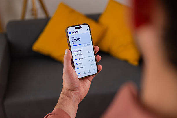 istock Man checking his health app on smartphone at home 2218409707