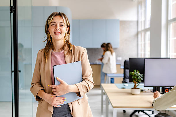 istock Professionals engage in a modern office space while working together and enjoying their tasks in a bright environment 2218409765