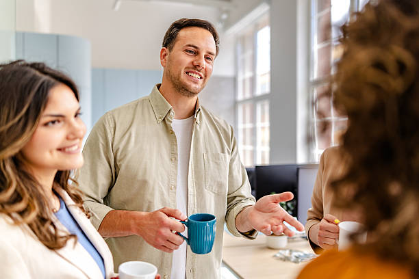 istock Professionals engage in conversation and collaboration in a modern office setting 2218409867