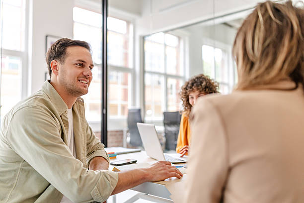 istock Smile and collaboration in a modern office environment during a team meeting 2218410093