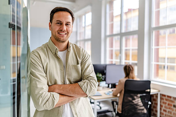 istock Smiling business professional in modern office environment enjoying collaboration and productivity with colleague 2218410344