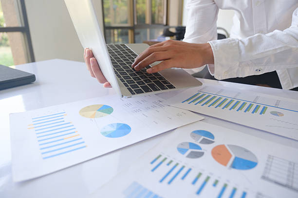 istock Professional businessman using computer laptop analyzing financial graphs investment marketing data. 2218414086