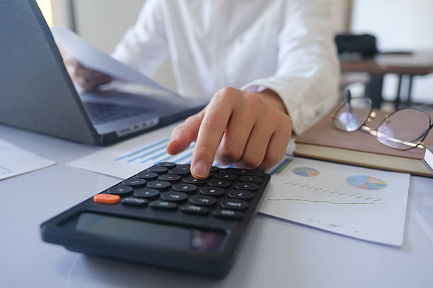 istock Close up accountant banker or bookkeeper making calculations with calculator. 2218414101