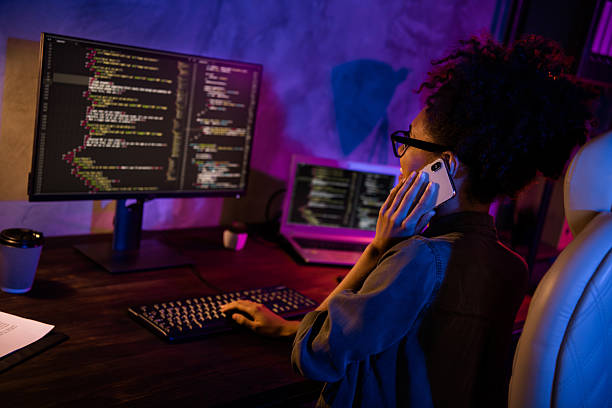 istock Phot of lady freelancer use modern gadget screen speak talk smart phone solve operating system error in evening late workplace 2218415776