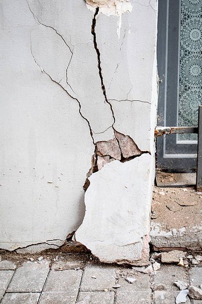 istock Cracked Wall with Missing Plaster Near Window. Building emergency condition 2218416022