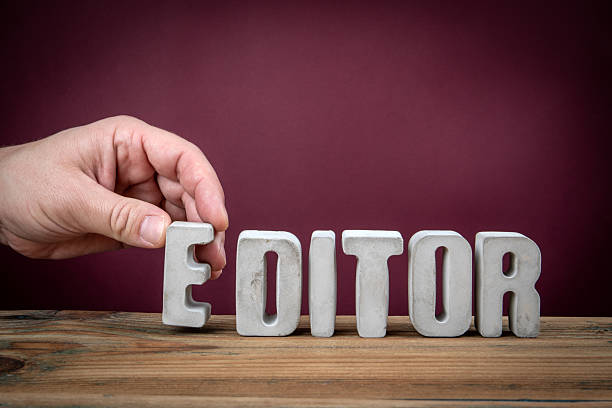 istock EDITOR Word Created from Concrete Alphabet Letters on Wooden Desk 2218416047