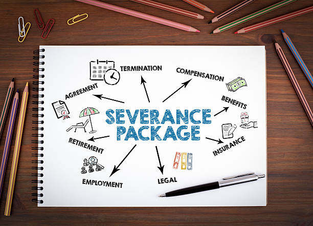 istock SEVERANCE PACKAGE Concept. Notebooks, pen and colored pencils on a wooden table 2218416089
