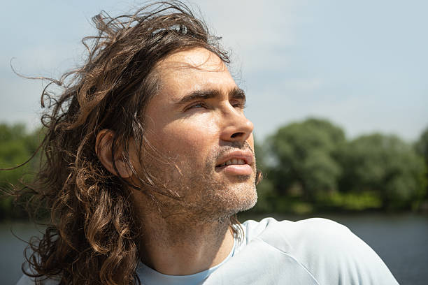 istock Thoughtful handsome brunette man with Long Hair by River 2218419688