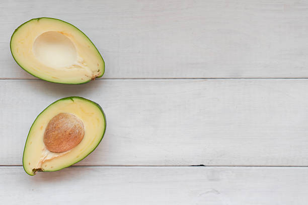 istock Avocado halves on wooden 2218420809