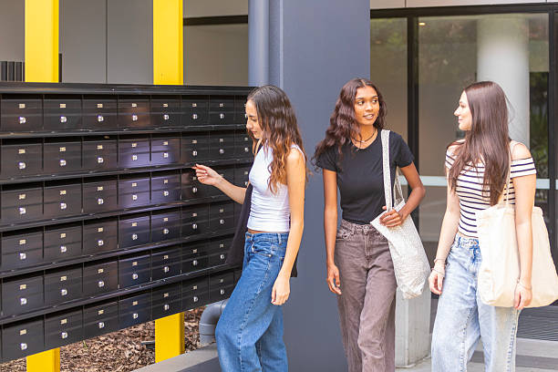 Young women leaving an apartment building