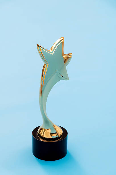 istock Gold star trophy on blue background 2218422169