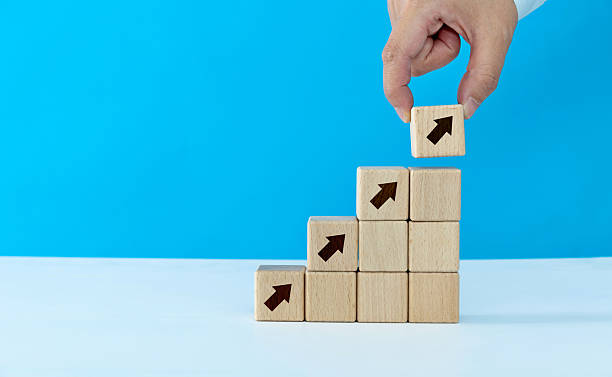 istock Wooden block staircase with arrow up 2218422365