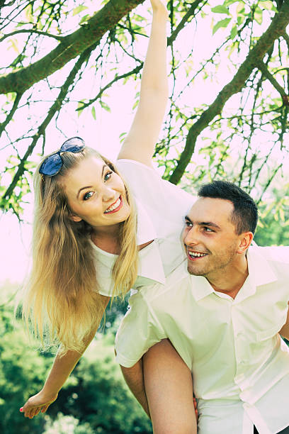 Love, romantic walks concept. Man and blonde woman having romantic date in park, happy being together.