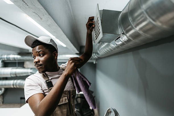 istock Worker performs maintenance on ventilation system in commercial building during daytime hours 2218425976