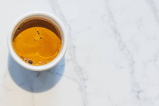 Freshly brewed espresso served in a small cup on a table, capturing the rich aroma and bold flavor of a perfect coffee moment