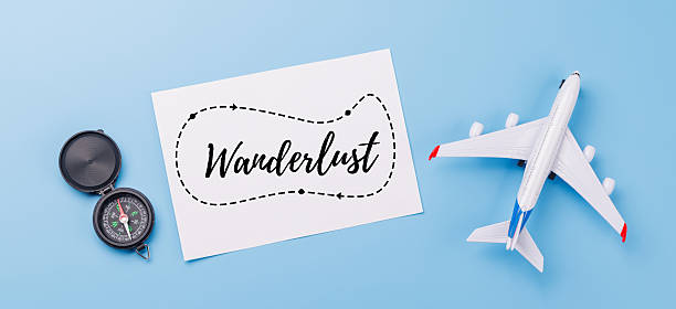 istock Travel-themed flat lay with card, compass, toy airplane 2218427221
